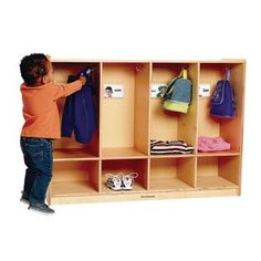 a little boy that is standing in front of a locker