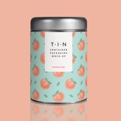 a canister with peaches on it sitting on a table in front of a pink background