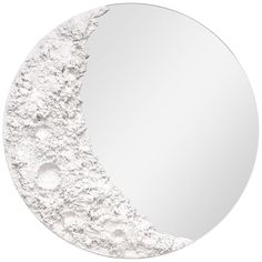 a round mirror with white paint on it