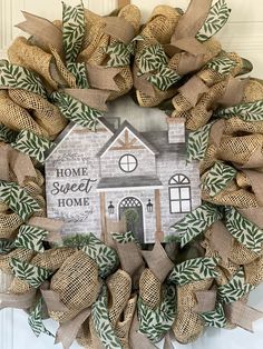 a burlock wreath with a house on it that says, home sweet home