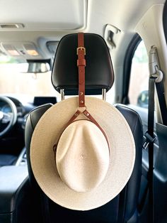 This Leather Hat Holder for cars and trucks is a simple and practical solution for keeping your hats secure while you drive. It is crafted from top-quality leather and designed to fit securely in your vehicle's headrest. Its durable construction allows for repeated use and its adjustable straps let you customize the fit. Available in brown and black genuine Italian leather. Fits up to a Size 8 / 25" circumference hat. Cowboy Hat Rack, Hat Holder, Chapeau Cowboy, Leather Hat, Hat Rack, Leather Hats, Cars And Trucks, Leather Projects, Cow Boy