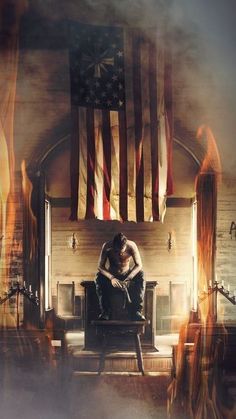 a man sitting on top of a chair in front of an american flag and fire