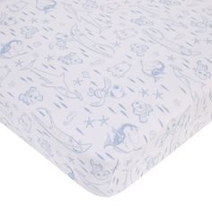 a blue and white baby crib sheet with cartoon animals on it's side