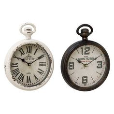 two clocks are sitting side by side on a white background, one has roman numerals