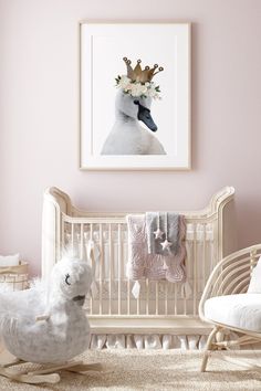 a baby's room with a white crib, rocking chair and pink walls