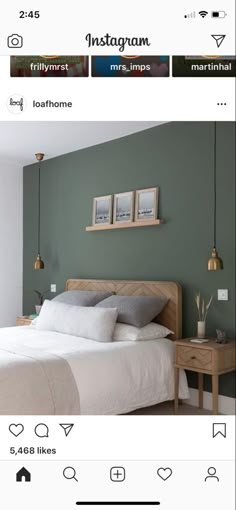 a bedroom with green walls and white bedding in the middle, two pictures on the wall above the bed