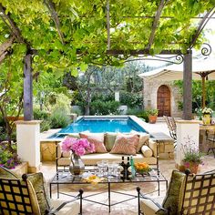 an outdoor living area with furniture and a pool