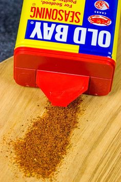 a container of seasoning sitting on top of a wooden table