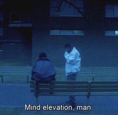 two people sitting on a bench in front of a building with the words mind elevation, man