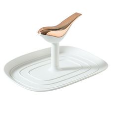 a white and gold chair sitting on top of a white tray with a brown seat