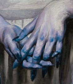 two hands are holding each other over a table with blue paint on it's surface