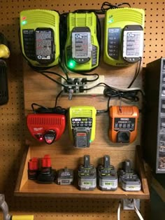 there are many different types of tools on the shelf in this shop, including two walkie talkies