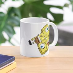 a white coffee mug with a cartoon character on it