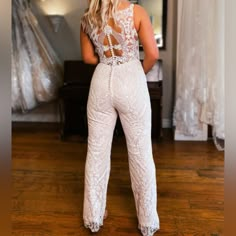 the back of a woman's white lace jumpsuit