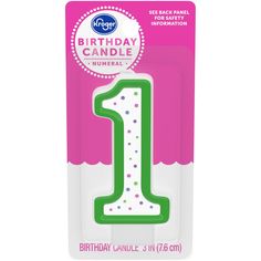 a pink and green birthday candle with the number one on it's front side