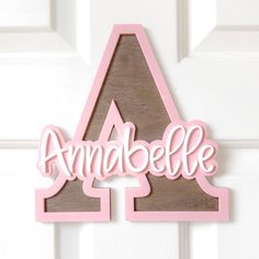 a wooden sign with the word annobelle on it hanging from a white door