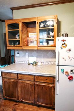 a white refrigerator freezer sitting inside of a kitchen