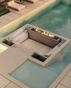 an outdoor fire pit in the middle of a swimming pool