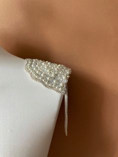 These gorgeous pearl epaulettes are unique and one of a kind piece of shoulder jewelry to go with your wedding dress, party dress or to add a touch of elegance to any formal outfit, letting you sparkle on your special event. Handmade of real pearls and sparkling rhinestones, these shoulder epaulettes will adore your outfit and make you feel like a red carpet celebrity. If you are looking a perfect finishing to your wedding dress, these epaulettes will make your bridal look gorgeous.   No matter Wedding Epaulettes, Elegant Embellished Jewelry For Events, Evening Embellished Pearl Jewelry, Elegant Bridal Accessories With Pearl Embroidery For Ceremony, Evening Pearl Jewelry Embellished, Elegant Embellished Bridal Accessories For Ceremony, Beaded Pearl Backdrop Necklace For Evening, Elegant Beaded Wedding Backdrop Necklace, Glamorous Beaded Backdrop Necklace For Weddings