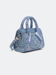 House signature motifs adorn iconic forms in new, seasonal fabrications for Pre-Fall 2024. The denim Bandana Micro Triangle Bag is embroidered with the house's bandana paisley and features top handles with tied paisley scarf accents and a detachable denim shoulder strap. PRE-FALL 2024 COLLECTION MADE IN ITALY 100% COTTON Ch Matryoshka Bag, Bandana Purse, Denim Bandana, Paisley Scarf, Triangle Bag, Paisley Scarves, Shorts Sweatpants, Denim Outerwear, Vintage Jerseys