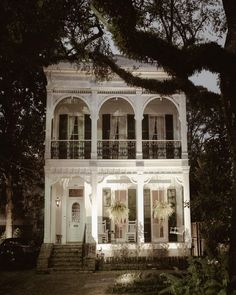 a large white house with many windows and balconies