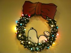 a christmas wreath with lights and a cartoon character on it