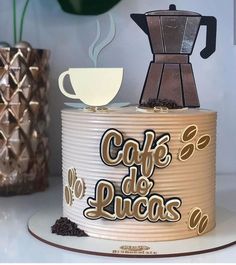 there is a cake that says cafe de lucias on it and has coffee coming out of the top