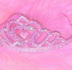 a tiara on top of a pink furry material