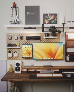 a desk with two computer monitors, keyboard and mouse on it next to other items