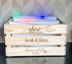 three wooden crates with different colored lights in them