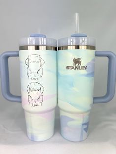 two stainless steel tumblers with different designs and names on them, one has a straw in it