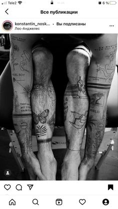 two people with tattoos on their legs are standing next to each other and holding hands