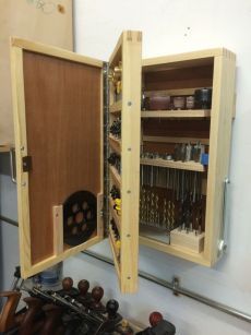 an open cabinet with many tools in it