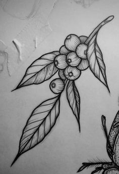 a bird sitting on top of a table next to a leaf and flower tattoo design