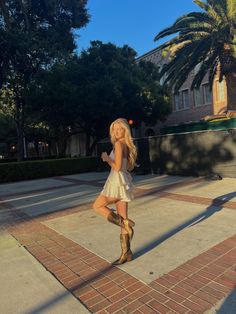 White Dress With Boots Country, Hoco Cowgirl Boots, Cowgirl Boots With Homecoming Dress, Hoco Dresses With Cowgirl Boots, Short Flowy Dress With Cowboy Boots, Prom Dress And Cowboy Boots, Sundress Country Concert, Sundress With Cowgirl Boots, Western Flowy Dress