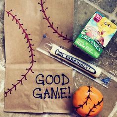 a paper bag with some writing on it next to an orange and a marker that says good game