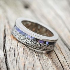 a wedding ring sitting on top of a wooden table