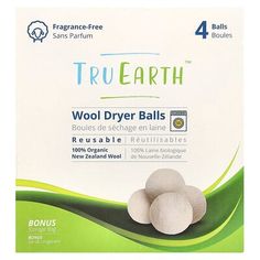 three balls of wool dryer balls in front of a box