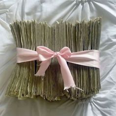 a close up of a bunch of sticks with pink bows on it's ends