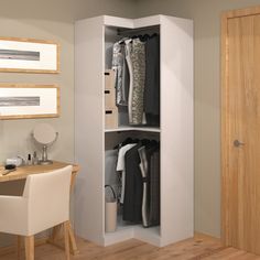 an open closet with clothes on hangers and a desk in the corner next to it