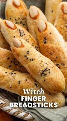 some bread sticks are in a wicker basket with the words witch finger breadsticks