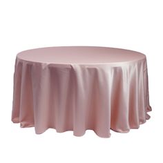 a round table with a beige cloth on it's top and an empty white background