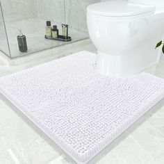 a bathroom with a white rug on the floor