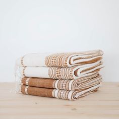 four folded towels stacked on top of each other