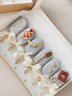 a box filled with lots of different types of cake on top of a white table