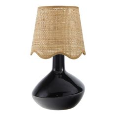 a black table lamp with a burlap shade on the top and an oval base