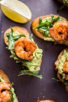 shrimp and guacamole sandwich with lemon wedges on the side, ready to be eaten