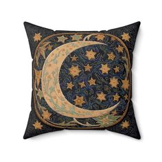 a decorative pillow with an image of the moon and stars in blue, gold and black