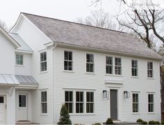 a white two story house with black shutters