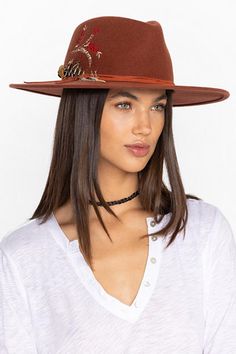 Crafted from 100% wool, the Hummingbird Heather Hat is available in an earthy rust color. Featuring a mid-height crown and a wide brim, this hat is finished with intricate placement embroidery and a decorative feather placed thoughtfully at the hatband. Style with a denim-on-denim look and western style boots for an eclectic ensemble. Johnny Was Women's Hummingbird Feather Hat in Rust Brown, Denim Brown Fall Hat Bands, Brown Short Brim Felt Hat For Kentucky Derby, Brown Flat Brim Fedora For Kentucky Derby, Adjustable Brown Fedora For Fall, Brown Wide Brim Felt Hat For Fall, Brown Flat Brim Fedora For Fall, Chic Brown Fedora For Kentucky Derby, Chic Brown Hat For Fall, Chic Brown Fall Hat